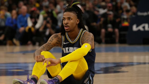 Ja Morant sits on the court during a game.